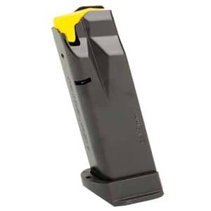 Black handgun magazine with a yellow follower, standing at an angle on a base.