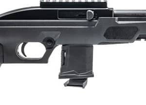 Side view of a black semi-automatic rifle with a pistol grip, magazine, and top rail