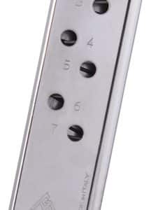 Metal handgun magazine with numbered witness holes and a dark polymer base, shown at an angle.