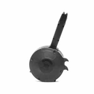 Black drum-style firearm magazine with a long feed handle, shown against a white background
