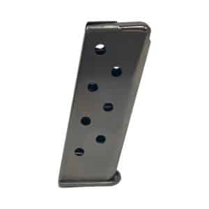 Metal handgun magazine with circular witness holes, tilted diagonally against a white background.