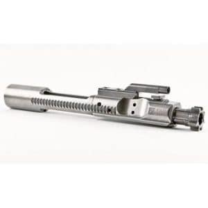 Metal bolt carrier group for a rifle laid on a white background