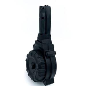 Black drum-style firearm magazine with a winding/base and textured outer rim, shown at an angle from the side.