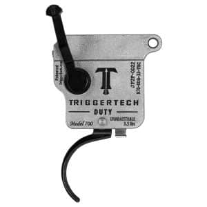 Close-up of TriggerTech Duty Model 700 rifle trigger with a black lever and curved linkage, metal housing labeled TRIGGERTECH DUTY.