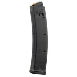 Black firearm magazine with a copper-colored cartridge visible at the top, angled to the left.