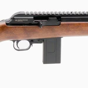 Bolt-action rifle with a wooden stock, detachable box magazine, and a long suppressor-style muzzle, brand name Bushranger visible on the receiver rail while viewed from the side.