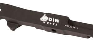 Black DIN Works XGMR-1 metal tool with curved end hooks and a central hole; a bicycle maintenance accessory.