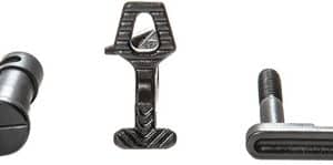 Three metal furniture fasteners laid out: a cam bolt on the left, a central nut-like piece, and a T-slot bolt on the right.