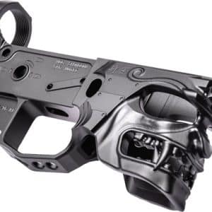 Grey firearm lower receiver with a skull-shaped grip accessory attached, giving the weapon a stylized, menacing appearance