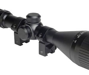 Rifle scope with adjustable turrets and two mounting rings on a rail, viewed from the eyepiece end