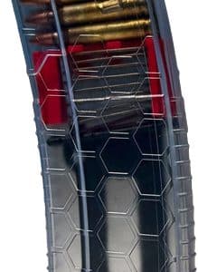 Transparent handgun magazine loaded with bullets, showing rounds at the top.