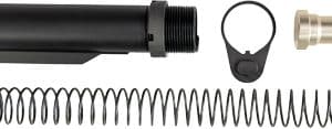 Disassembled AR-15 style buffer assembly: black buffer tube, long recoil spring, end cap, and detent ring.