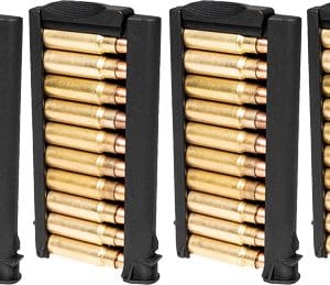 Four black magazines filled with brass ammunition lined up side by side.