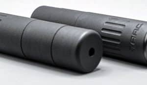 Two black cylindrical metal components with grooved ends lying side by side on a light surface.