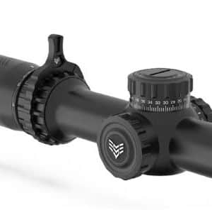 Black rifle scope with elevation and windage knobs and a large objective lens, used for aiming at targets.