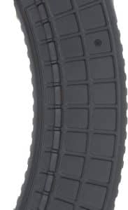 Curved black polymer rifle magazine with a ribbed surface and labeling at the base.