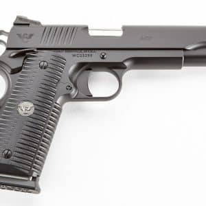 Close-up side view of a gray semi-automatic pistol with textured grip and exposed barrel, showing the slide and trigger guard.