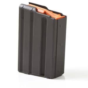 Black rifle-style magazine with an orange follower, standing upright on a white surface.