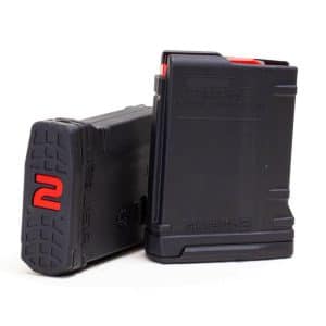 Two black polymer magazines, one upright and one lying flat, with red followers visible at the top (gun/airsoft accessory).
