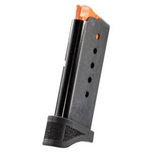 Metal handgun magazine with an orange follower visible at the top and a textured base plate (standing upright).