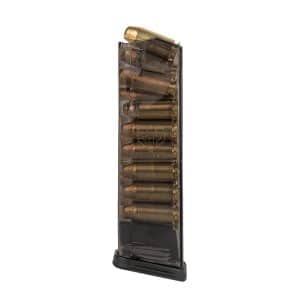 Vertical handgun magazine filled with brass cartridges, standing upright on a base.