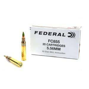Box of Federal 5.56mm ammunition (FC855), 20 cartridges, with two brass bullets nearby on a white background.