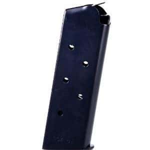 Blue metal pistol magazine standing upright, with feed lips at the top and visible cartridge holes on the side.