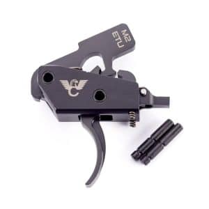 Black compact trigger-style tool with a folding lever and an eagle emblem, plus two small cylindrical adapters nearby.