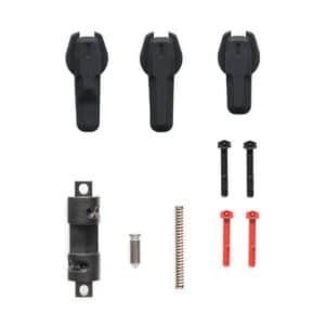 Parts kit with multiple small components: three black plastic pieces at top, two small black metal/ plastic bars, a black hinge-like piece, screw, long spring, and two red levers.