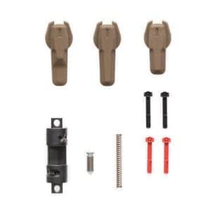 Assorted cabinet hardware parts arranged on white background, including brown plastic handles, black mounting pieces, red and black connectors, a spring, screw, pin, and cylindrical fastener.