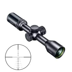 Black riflescope with 3 adjustment dials and a rightward lens, shown at an angle; inset shows a circular target reticle with crosshairs and measurement marks.