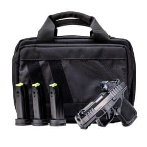Black tactical backpack with four handgun magazines visible in front, and a pistol secured to the lower front panel.