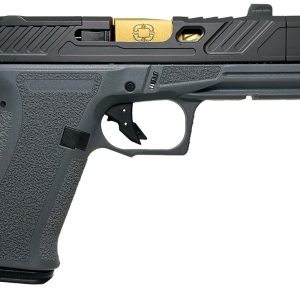 Profile view of a black semi-automatic pistol with a textured grip, serrated slide, and a gold-colored safety component visible on the slide.