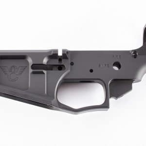 Lower receiver of a handgun in gray metal, showing the trigger opening and safety markings against a white background, unassembled.