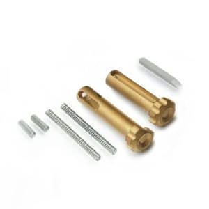Disassembled hardware kit with two brass cylindrical pins, two springs, small metal spacers, and a metal rod on a white background.