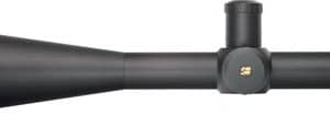 Black rifle scope with a large objective lens on the left and two adjustment turrets on the top and side.