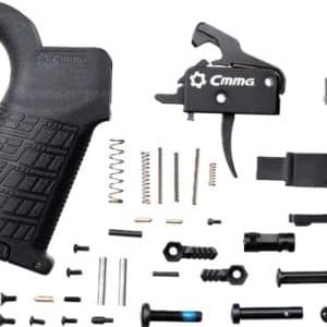Disassembled AR-style rifle lower parts kit with a black ergonomic grip and assorted springs, pins, and components laid out.