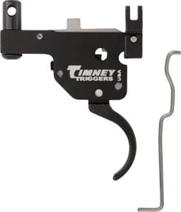 Timney Triggers firearm trigger assembly with curved trigger and mounting hardware, shown with a small L-shaped hex wrench