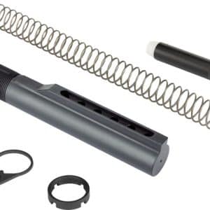 Disassembled airsoft gun part set: long metal coil spring, gray cylindrical housing with slots, black piston with white tip, and two circular retaining rings.