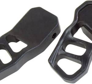 Pair of black bicycle pedal adapters with cutouts and a mounting bolt, used to clip into cycling shoes.