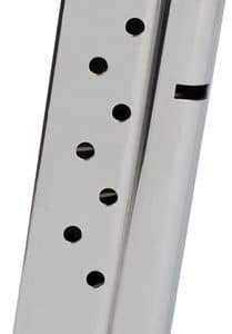 Silver metal handgun magazine viewed from the side, showing round-count holes along its length.