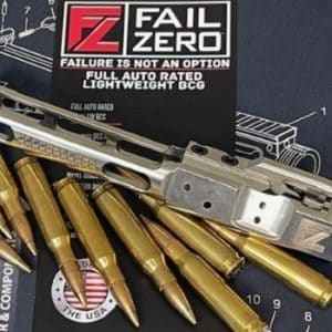 Silver AR-15 upper receiver and a row of gold torpedo-style rifle cartridges on a dark work mat featuring the Fail Zero branding.