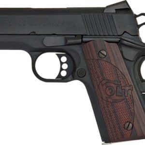 Compact semi-automatic pistol with a dark metal finish and brown checkered wood grip; slide reads 'Colt Defender'.
