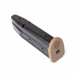 Handheld stapler with a black body and a tan curved front cap facing right, resting at an angle.