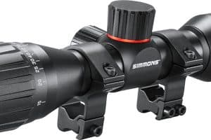 Rifle scope with two mounting rings and a large adjustment knob, black with red accent, brand Simmons ProTarget.