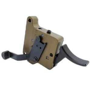 Tan-colored firearm component with a black mounting bracket and curved black levers, shown from the side.