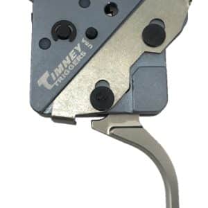 Close-up of a Timney Triggers firearm trigger assembly with a blue-gray housing and a curved silver trigger/lever.