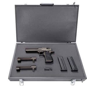 Open hard foam case holding a semi-automatic pistol with two magazines and a spare grip panel, arranged in a protective insert.