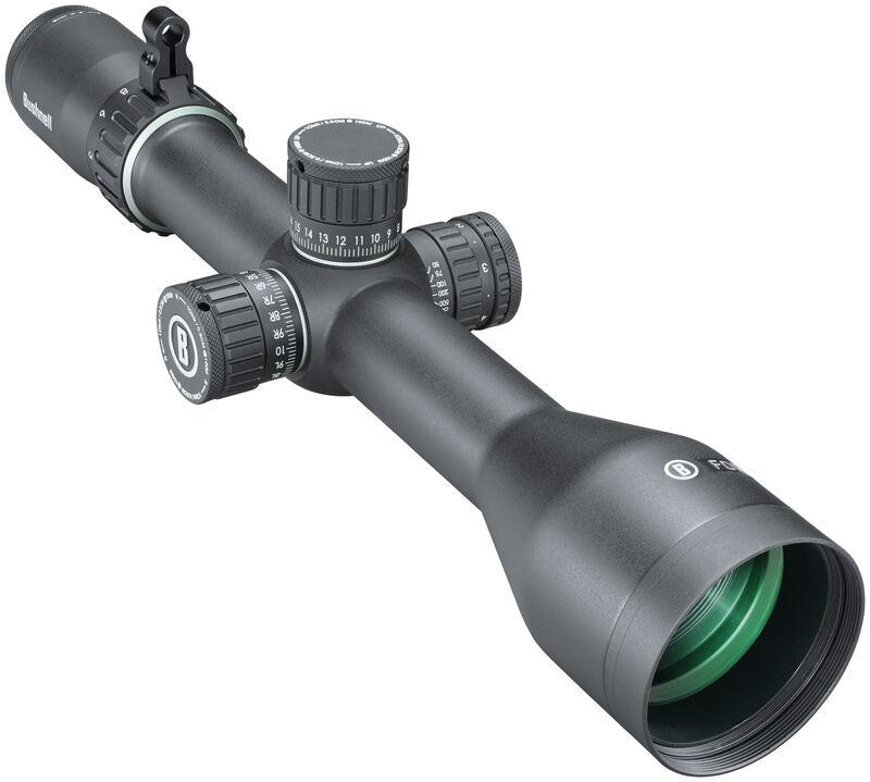 Black Bushnell rifle scope with four adjustment turrets and a green-tinted objective lens, mounted for aiming far targets.