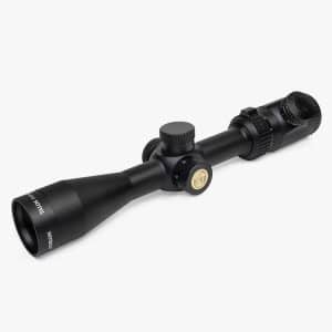 Black rifle scope with adjustable turrets on a white background, shown at an angle.